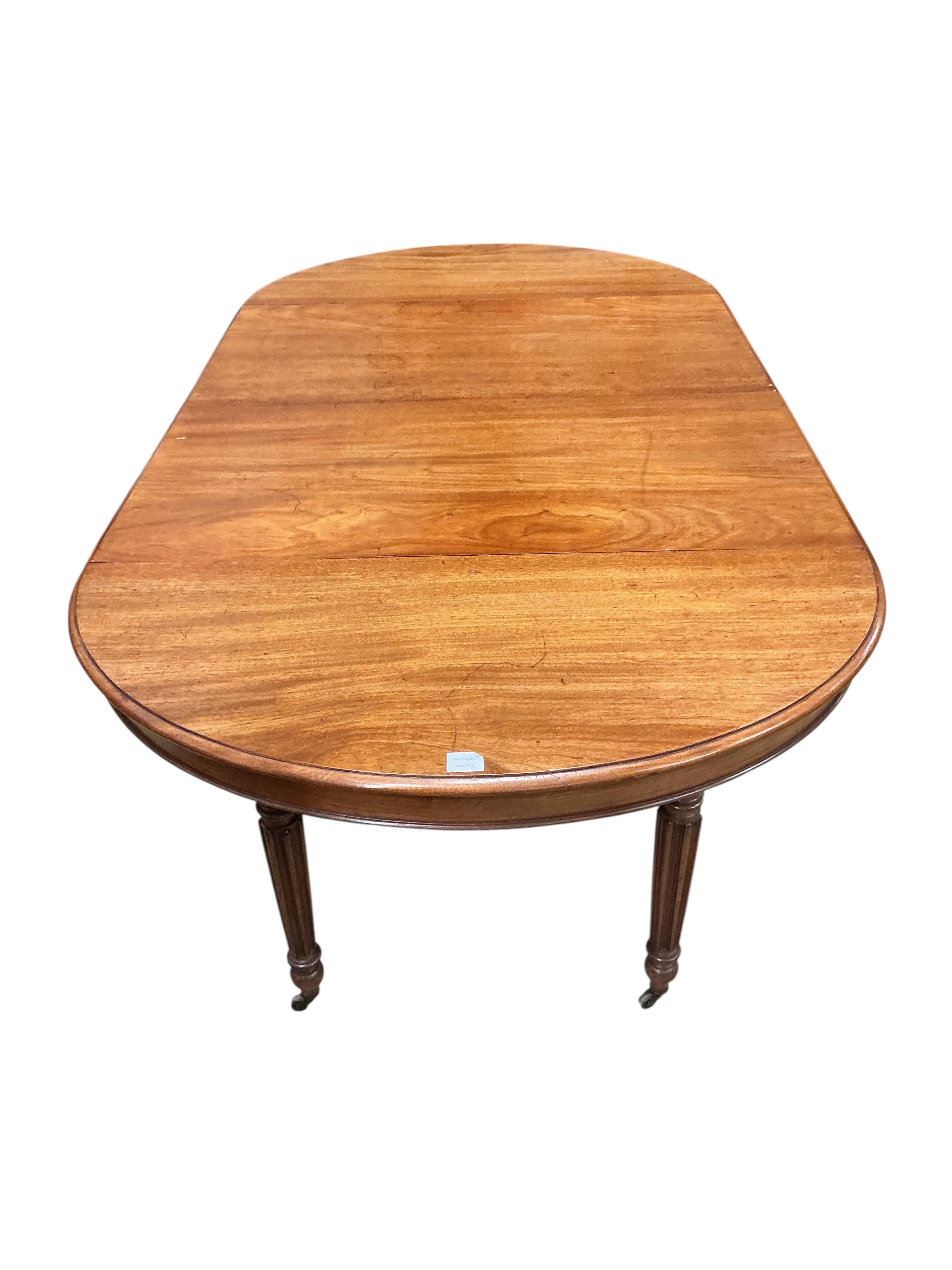 A 19th century French oval mahogany extending dining table, length 214cm extended, two spare leaves, width 102cm, height 70cm